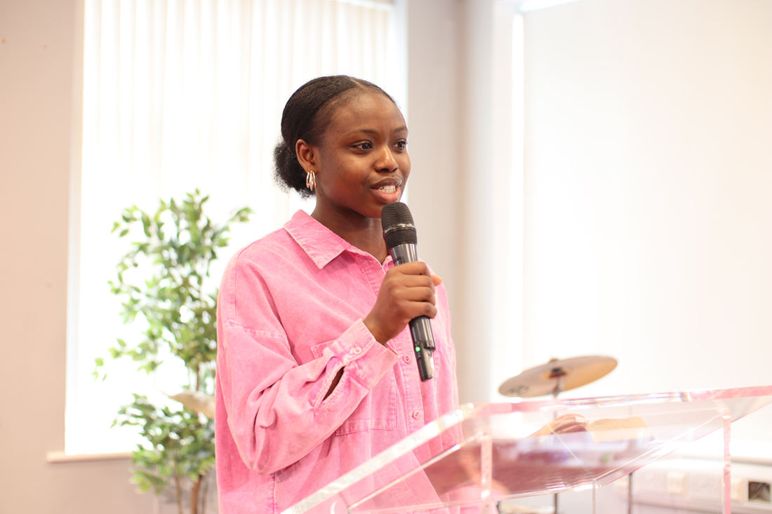 A young member sharing her testimony